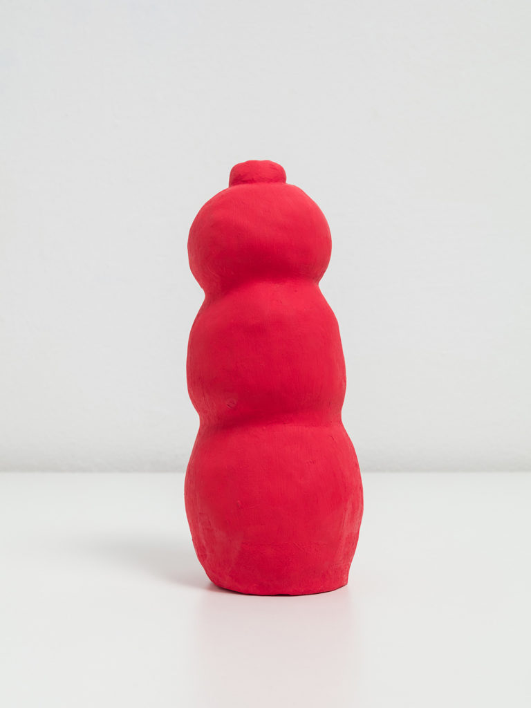 A ceramic sculpture of London’s peanut butter Kong painted red. It has the shape and mystique of a sex toy.