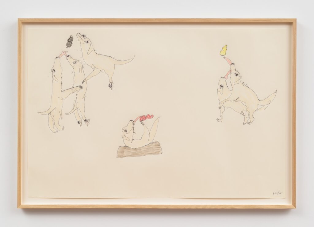 “Kong Play, One Two Three” is a minimalist drawing on cream-colored paper, framed in light wood. The artwork features several loosely sketched blonde English Labrador Retrievers, drawn in a simple style with thin black lines and light beige shading. On the left, three dogs stand upright, two of them reaching up with their tongues stretched towards a black Kong floating above them, while the third dog is supporting the others. In the center, a dog lies on its back on a brown bed, holding and licking a red Kong. On the right, two dogs stand upright, one behind the other, both reaching up with their tongues extended toward a yellow Kong above them. The dogs have expressive faces, and the overall style is whimsical and playful.