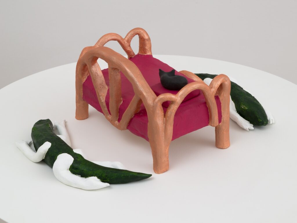 In this view of “Louisiana Day Bed” from the back, the second Alligatorgil is fully visible. So is the rear of the bed, including the metallic copper back of the bed, along with the back of the cat's ears.