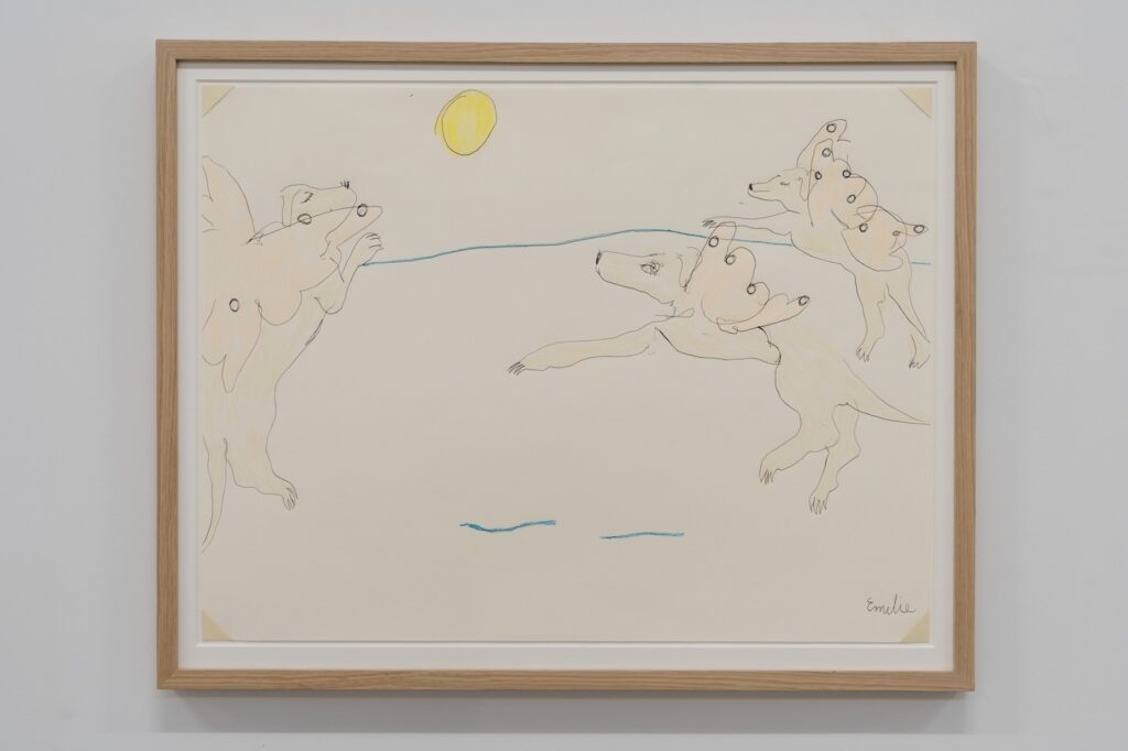 "London Afterlife" is a colored drawing on white paper slightly larger than a cookie tray. The drawing is framed in oak. Created with ballpoint pen and crayon, the image depicts three representations of a blonde-haired London with peach-colored butterfly wings emerging from her back. These avatars flutter in the sky beneath a warm, bright yellow sun.