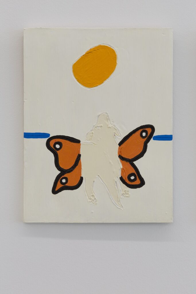 Focused on the center tile, the pads of the butterflydog's back feet are visible as she gazes upwards towards the sun.