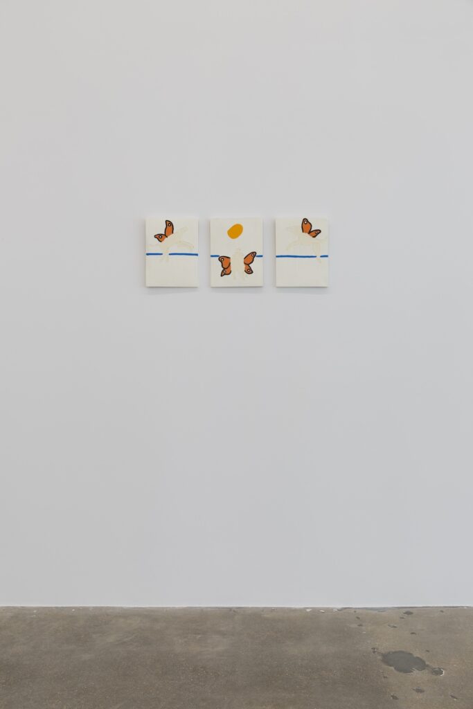 The bold brightness of the blue, the orange, and the golden yellow pop in this installation view of "London Flies Over the Ocean".