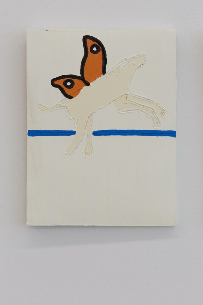 Closeup, the delicate markings on the surface of the left tile become apparent, especially around the butterflydog's eyes.