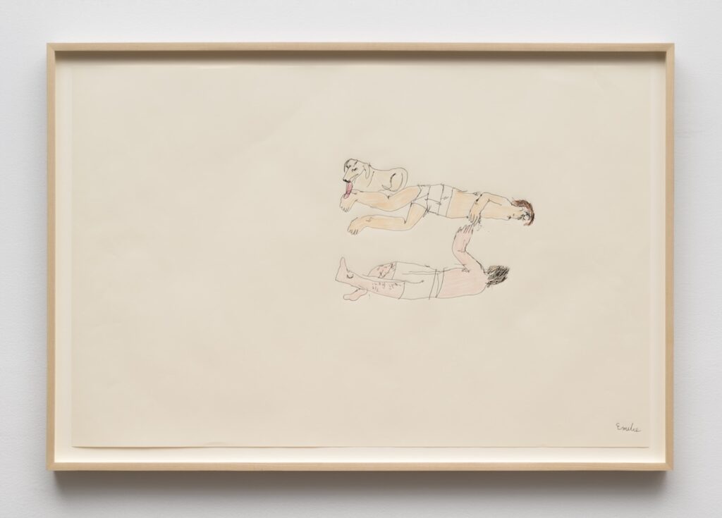 A minimalist drawing on off‑white paper in a light wood frame. In the center of the page, are Kirby, Emilie and London arranged horizontally in a loose S‑shaped curve, floating against the blank background. At the top is London lying on her stomach facing to the right, with her front legs stretched forward and back legs extended behind. Her tongue hanging out and licking Emilie’s foot. Slightly below London is Emilie with light skin, short brown hair, and wearing light-colored underwear. Emilie is lying on their stomach, also facing right, with arms reaching forward toward Kirby's head. Kirby has light skin and darker, short hair, and is lying on his back and facing left towards Emilie. He is also wearing light-colored underwear. One arm bends upward towards Emilie, and his legs are very long and hairy. The drawing style is loose and childlike, with thin, uneven outlines and soft, pale colors. The rest of the paper around the small central scene is empty.
